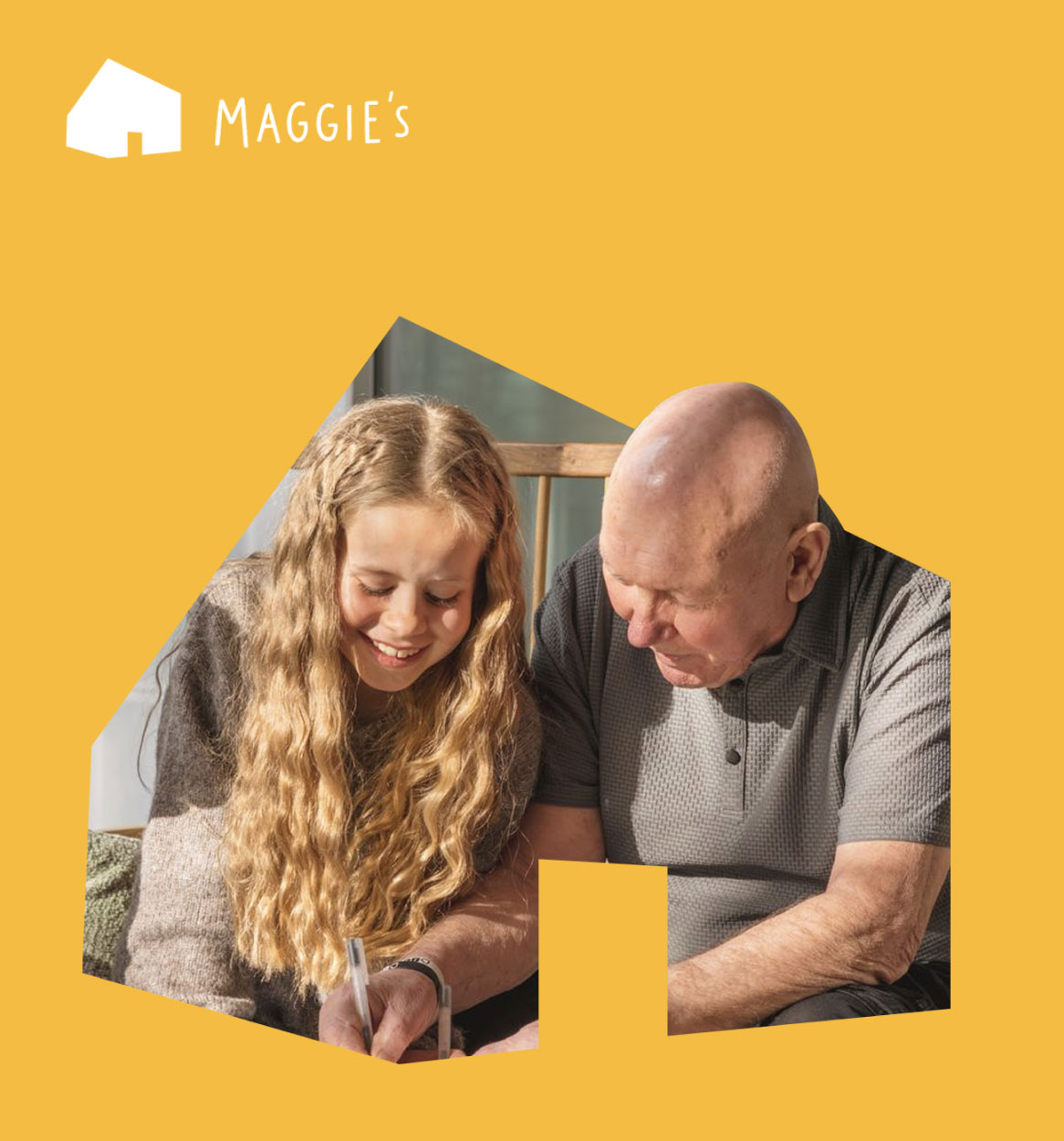 Young Girl and Older Man smiling and writing | Maggie's