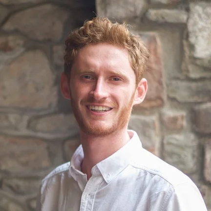 A circular headshot of Gwilym, Giant Digital's Business Development Director, smiling and wearing a white shirt.